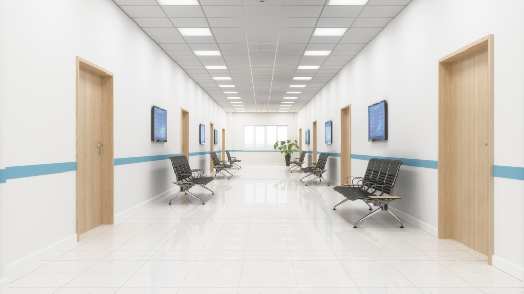 white corridor with LED lighting, black seating and TVs. 