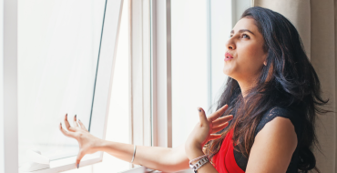 woman opening a window due to heat